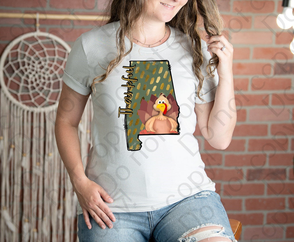 11-57 Thankful in a shape of Alabama with a turkey and a green poke a dot background Completed Tee